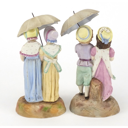 2416 - Pair of 19th century continental bisque figures, each of three children under a parasol, blue anchor... 