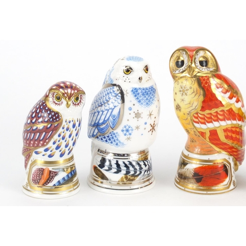 2600 - Four Royal Worcester bird candle snuffers comprising tawny owl, snowy owl, little owl and goldfinch,... 