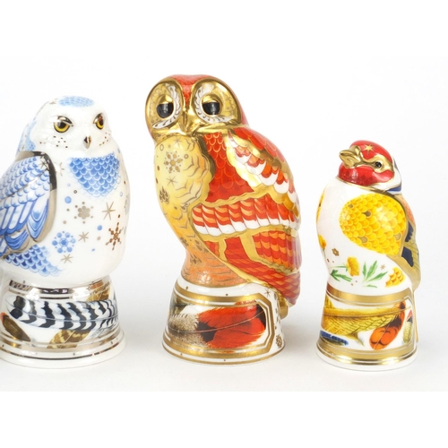 2600 - Four Royal Worcester bird candle snuffers comprising tawny owl, snowy owl, little owl and goldfinch,... 