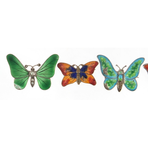 813 - Three silver and enamel butterfly brooches and one other including one set with five seed pearls, th... 