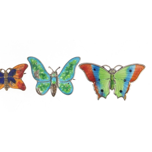 813 - Three silver and enamel butterfly brooches and one other including one set with five seed pearls, th... 