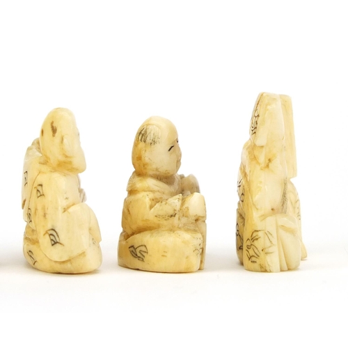 523 - Four Japanese carved ivory netsuke's and an okimono of a figure holding a gourd, three with characte... 