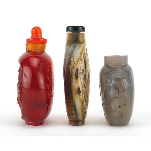 539 - Three Chinese snuff bottles comprising a mother of pearl example carved with figures an agate exampl... 