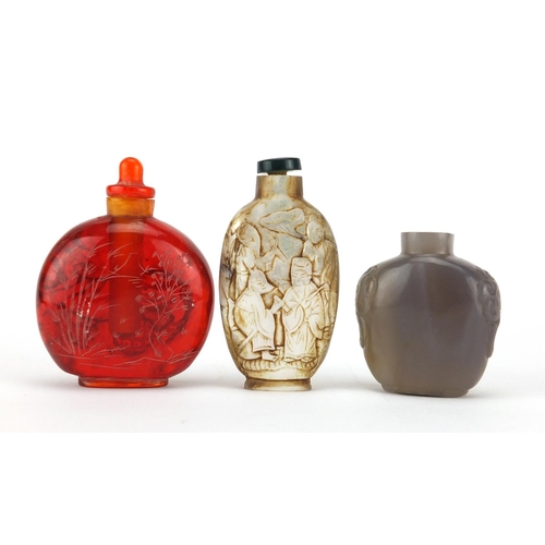 539 - Three Chinese snuff bottles comprising a mother of pearl example carved with figures an agate exampl... 