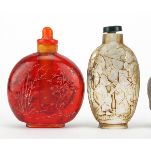 539 - Three Chinese snuff bottles comprising a mother of pearl example carved with figures an agate exampl... 