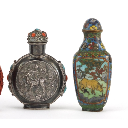 536 - Four Chinese snuff bottles including an unmarked silver example decorated in relief with two deer's ... 