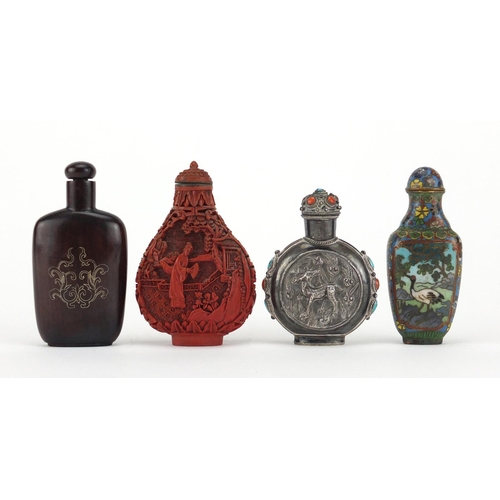 536 - Four Chinese snuff bottles including an unmarked silver example decorated in relief with two deer's ... 