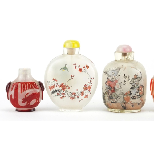 535 - Five Chinese glass snuff bottles comprising a Peking example and four others internally hand painted... 