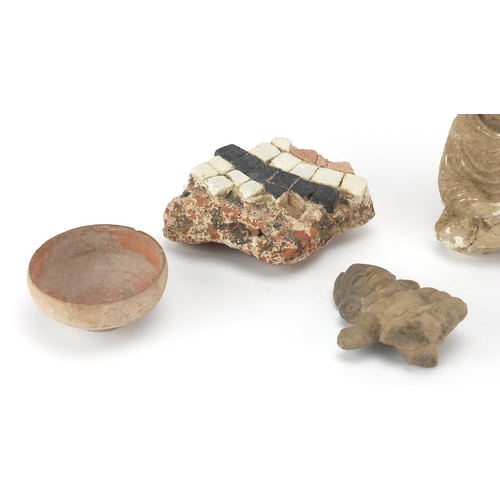 648 - Antiquities including a terracotta bowl from Petra and stone carvings, the largest 12cm in length