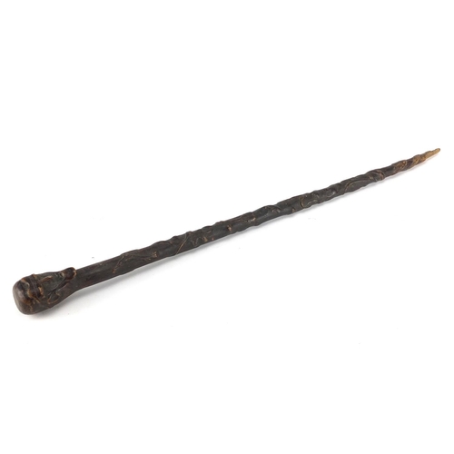 115 - Folk Art walking stick with carved figural pommel, the shaft carved with leaves and berries, 73cm in... 
