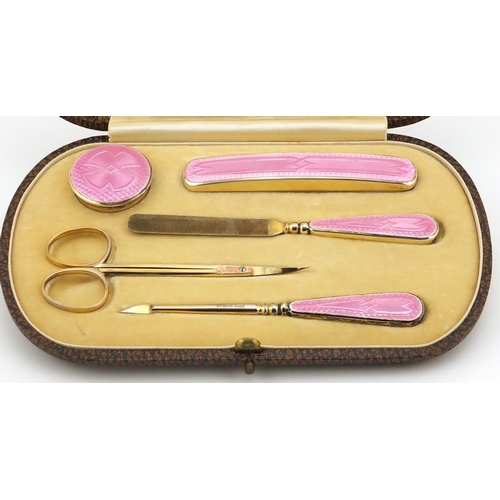 866 - Silver gilt and pink guilloche enamel five piece manicure set, by Henry Clifford Davis, housed in a ... 