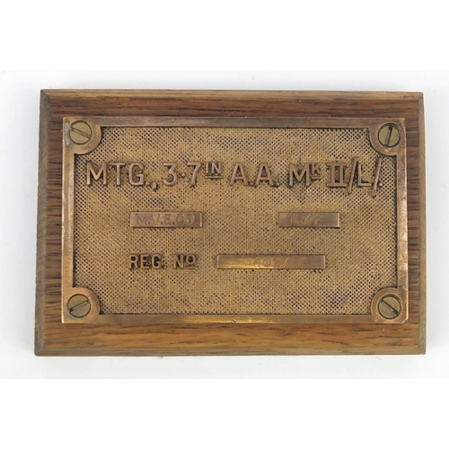 906 - Military interest MTG 3.7in A. A. Gun plaque, mounted on an oak base, 15.5cm wide