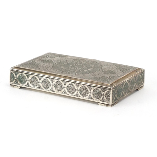 627 - Rectangular Persian silver cigarette box engraved with foliate motifs, the hinged lid opening to rev... 