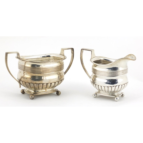 865 - Victorian silver demi fluted twin handled sugar bowl and matching cream jug, both with ball feet, by... 