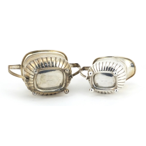 865 - Victorian silver demi fluted twin handled sugar bowl and matching cream jug, both with ball feet, by... 