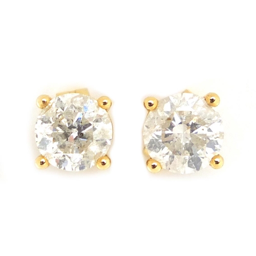920 - Pair of 14ct gold diamond solitaire earrings, approximate weight 1.8g