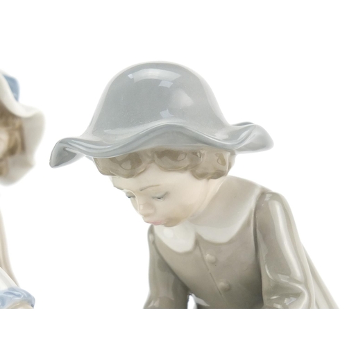 2276 - Lladro figure group of a young girl and boy with a kitten, 14cm high
