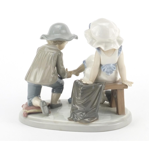 2276 - Lladro figure group of a young girl and boy with a kitten, 14cm high