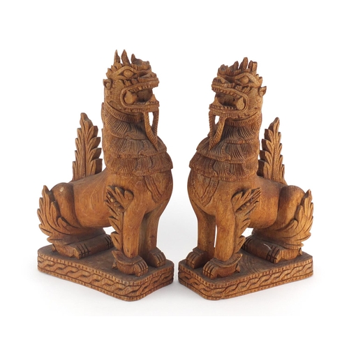 2355 - Pair of Balinese carved wood dragons, each 31.5cm high