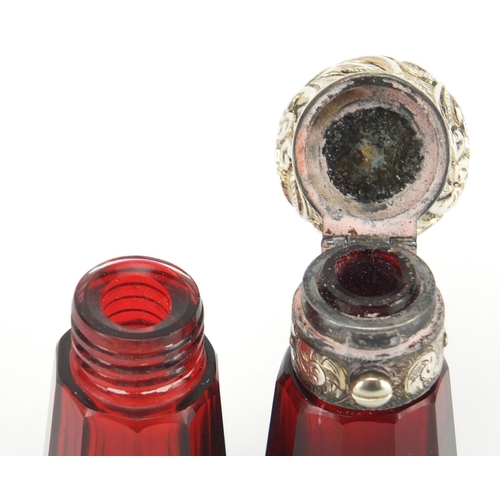 56 - Victorian ruby glass binocular double ended scent bottle having embossed unmarked silver mounts, 14c... 
