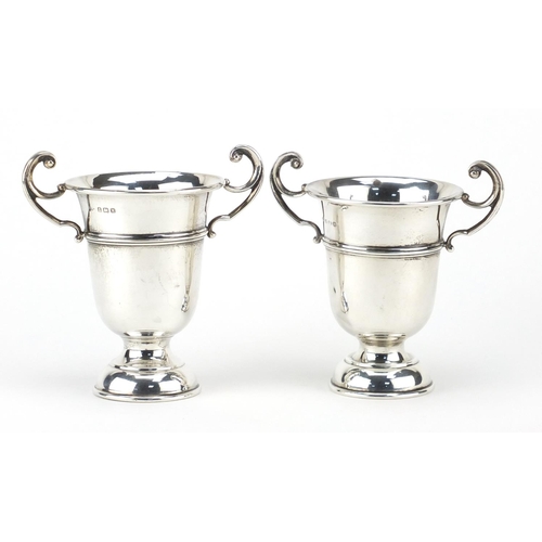 859 - Pair of silver twin handled trophies, by A E Poston & Co Limited, Birmingham 1937, 12cm high, approx... 