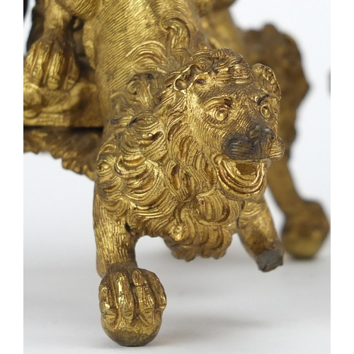12 - Pair of 19th century gilt bronze candlesticks chased with leaves having ram masks on lion bases, eac... 