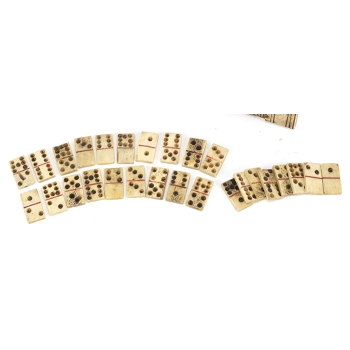 102 - 19th century prisoner of war bone dominoes and a carved cribbage board, the board 9.5cm wide