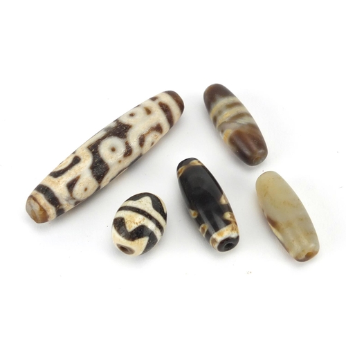 614 - Five Islamic agate beads, the largest 6cm wide