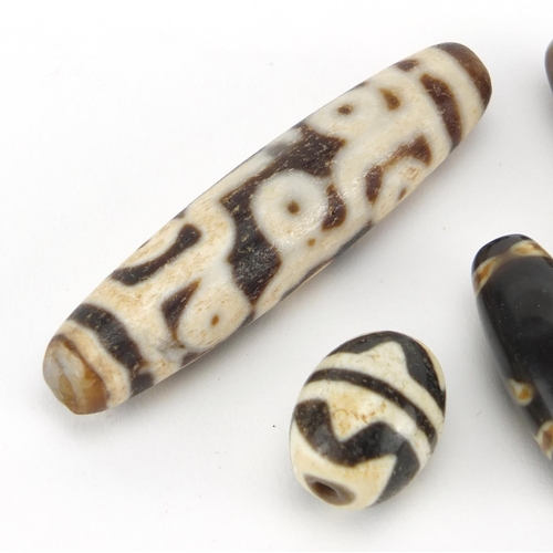 614 - Five Islamic agate beads, the largest 6cm wide