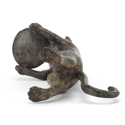 2303 - Bronzed model of a standing cat holding a plate, 27cm high