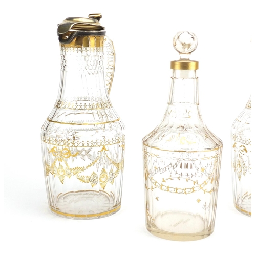 737 - Pair of early 19th century French cut glass claret jugs with silver gilt lids and a similar decanter... 