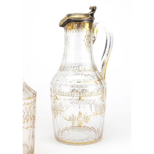 737 - Pair of early 19th century French cut glass claret jugs with silver gilt lids and a similar decanter... 