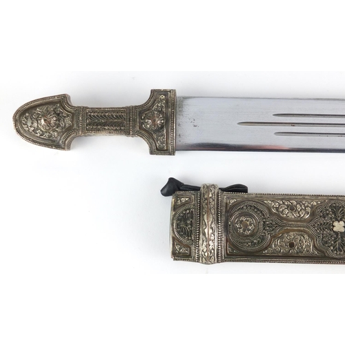 623 - Caucasian Kindjal dagger with silver coloured metal handle and scabbard, each having foliate motifs ... 