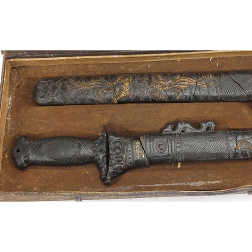 578 - Two Chinese gilt decorated black ink stone swords, housed in a fitted case with calligraphy, each 43... 