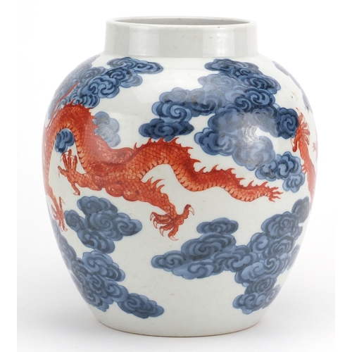 447 - Chinese blue and white porcelain vase, hand painted in iron red with two dragons amongst clouds, six... 