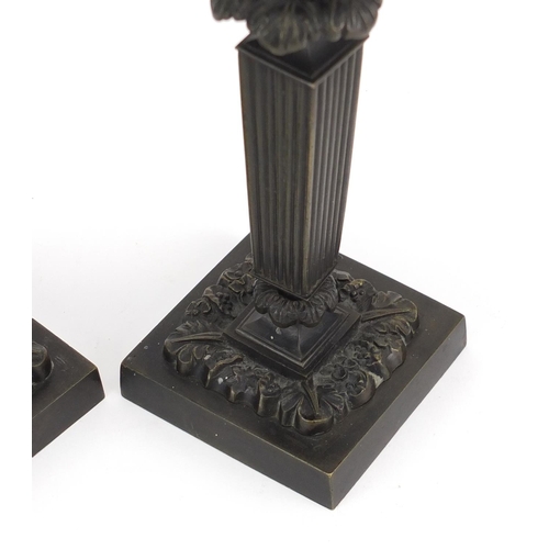 14 - Pair of 19th century classical patinated bronze candlesticks with tapering columns on square bases, ... 