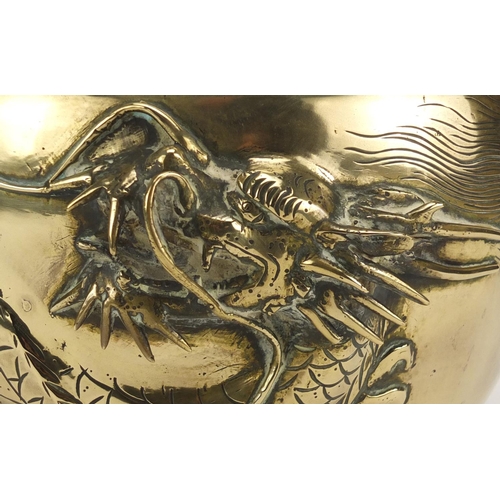 569 - Chinese bronze jardinière cast with a dragon, 19.5cm high x 28cm in diameter