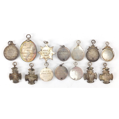 251 - Fourteen silver jewels, some with enamel including athletics, Blackheath Royal Golf Club, Football A... 