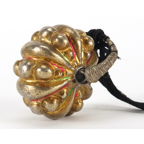 637 - Tibetan partially gilt unmarked silver pendant on cord, 5cm in diameter, approximate weight 42.4g