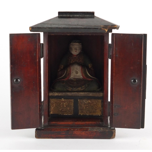640 - 19th century Asian painted wood figure of Buddha, housed in a red lacquered case, 21cm high