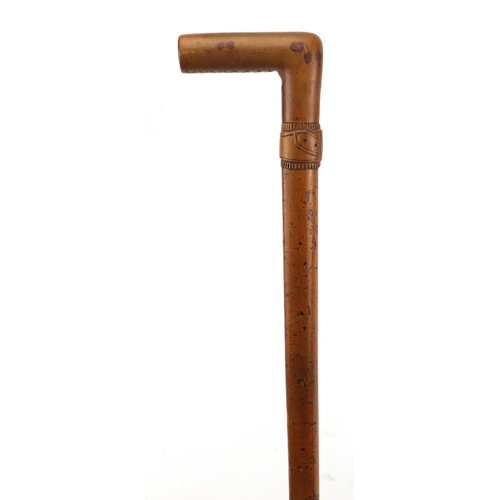 116 - Malacca walking stick with fruitwood handle and carved belt design collar, 82cm in length