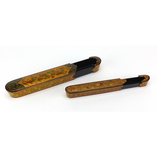641 - Two Islamic lacquered pen boxes hand painted with flowers, the largest 26.5cm wide