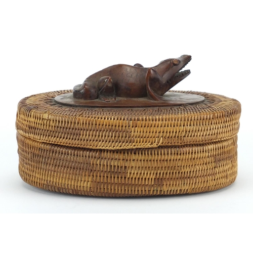 586 - Oriental oval wicker and hardwood container carved with a lizard, 16cm wide