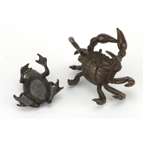 577 - Japanese patinated bronzes comprising a crab and a frog, the crab with character marks to the unders... 