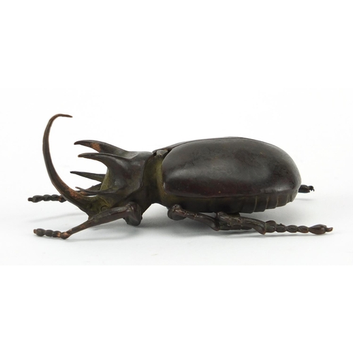 572 - Japanese patinated bronze rhinoceros beetles, with hinged wings and articulate legs, impressed chara... 