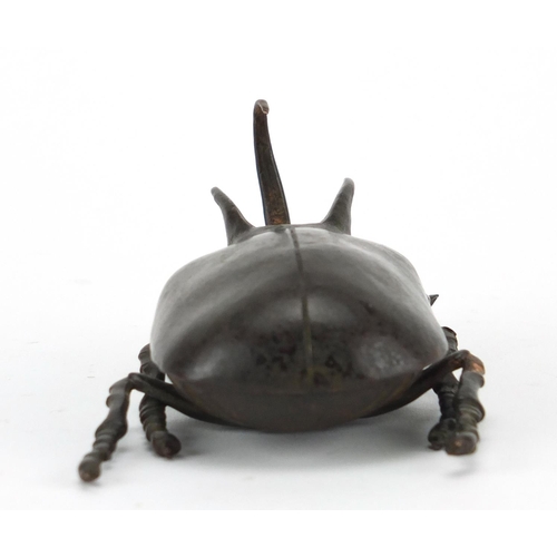 572 - Japanese patinated bronze rhinoceros beetles, with hinged wings and articulate legs, impressed chara... 