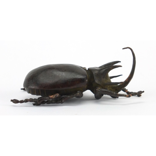 572 - Japanese patinated bronze rhinoceros beetles, with hinged wings and articulate legs, impressed chara... 