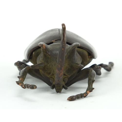 572 - Japanese patinated bronze rhinoceros beetles, with hinged wings and articulate legs, impressed chara... 