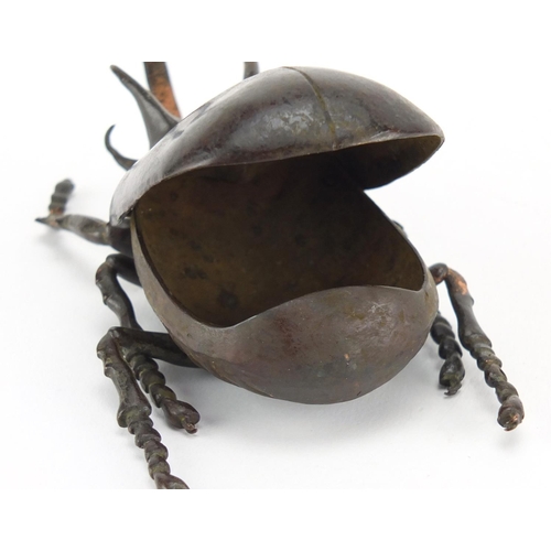 572 - Japanese patinated bronze rhinoceros beetles, with hinged wings and articulate legs, impressed chara... 