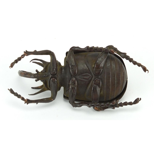 572 - Japanese patinated bronze rhinoceros beetles, with hinged wings and articulate legs, impressed chara... 